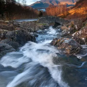 Ashness Bridge Print: Snow-Topped Skiddaw Over Raging River