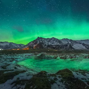 Aurora arch over a mountain range in Iceland