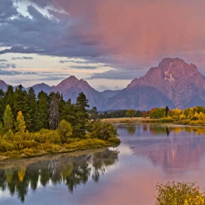 Autumn forests and Mount Moran at sunrise, reflecting in Oxbow Bend of Snake River at Grand Teton National Park, Wyoming, USA