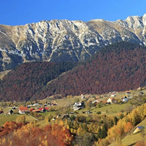 Autumn landscape of little village and mountain range in background, Piatra Craiului National Park, Magura, Carpathian Mountains, Brasov, Brasov County, Transylvania, Romania