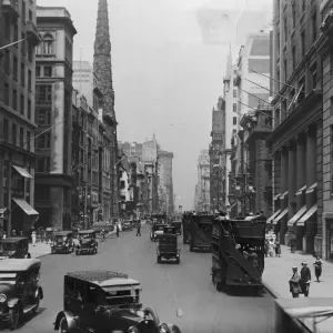 On The Avenue; busy street with automobiles and pedestrians