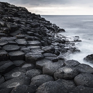 Basaltic rocks on the shore with waves, Giants Causeway, Coleraine, Northern Ireland, United Kingdom, Europe