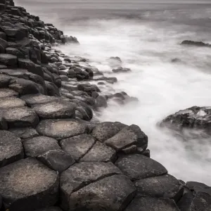 Basaltic rocks on the shore with waves, Giants Causeway, Coleraine, Northern Ireland, United Kingdom, Europe Basaltic rocks on the shore with waves, Giants Causeway, Coleraine, Northern Ireland, United Kingdom, Europe