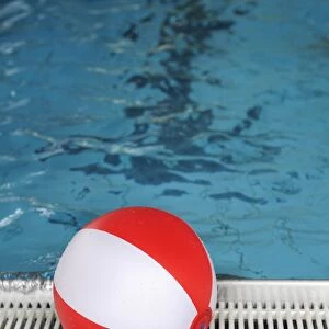 Beach ball at the edge of a swimming pool