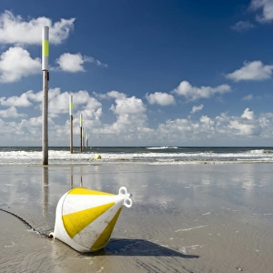 Beach, marker posts and a buoy, St Peter-Ording, Schleswig-Holstein, Germany