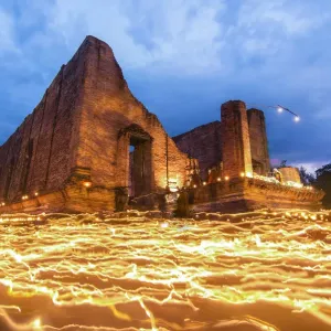 Beautiful candle light from buddhists are moving around big Buddha statue in evening Beautiful candle light from buddhists are moving around big Buddha statue in evening