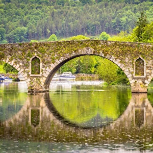 Beautiful Graiguenamanagh stone bridge with trees in the background on a rainy day, County Kilkenny, Ireland