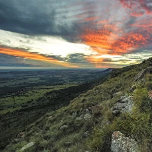 Beautiful Sunset from the top of the Magaliesberg Mountain Range looking towards the flat expanse of the agricultural North-West Province. Magaliesberg Mountain, North-West Province, South Africa
