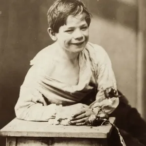 Beggar Boy Print circa 1890: A boy eating dry bread and onions Beggar Boy Print circa 1890: A boy eating dry bread and onions