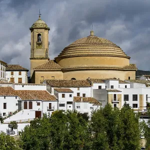 Bell tower and domed roof of Iglesia de la Encarnacion church with white houses below