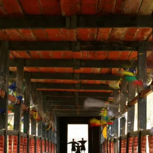 Bhutan, Paro, Paro Dzong, three boys (6-12) standing on covered bridge Bhutan, Paro, Paro Dzong, three boys (6-12) standing on covered bridge