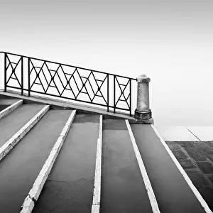 Black and white photograph of a bridge railing in the fog at the Fondamenta Nuove in the north of Venice, Italy