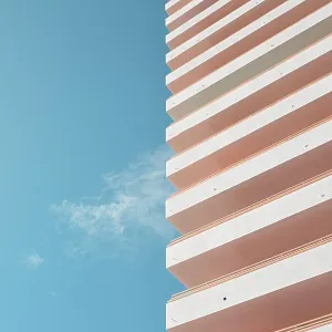 Blue sky, thin white cloud and white building