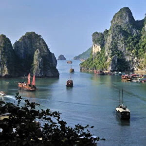 Boats and junks in Halong Bay, karst mountains in the sea, Vietnam, Asia