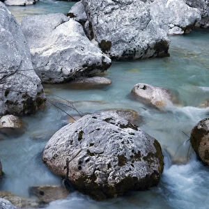Boulders and stones in the river bed of the Soca river, Soca Valley near Bovel, Triglav National Park, Slovenia, Europe