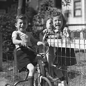Boy on tricycle w / girl