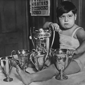 Print of a Young Boy with Baby Show Trophies, circa 1927 Print of a Young Boy with Baby Show Trophies, circa 1927