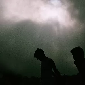Boys Silhouette against Dramatic Sky