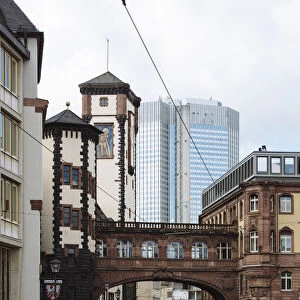 Bridge of Sights (SeufzerbrAOEcke) in the historic center and modern skyscraper in the background in Frankfurt am Main, Hesse, Germany