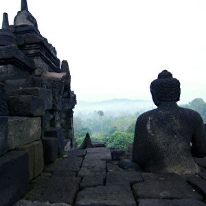 Buddha statue overlooking mountains
