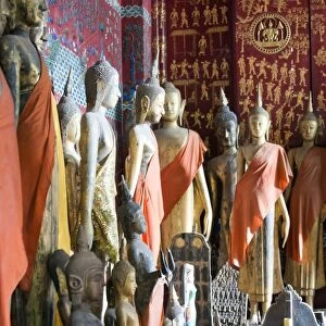 Buddha statues inside Royal Funerary Carriage House at Wat Xieng Thong. Luang Parbang, Laos