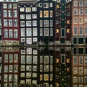 Building facades with a mirror image reflecting in a canal