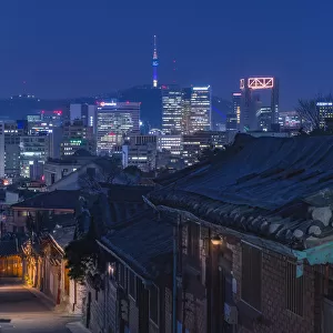Bukchon Hanok village at night with Seoul city background