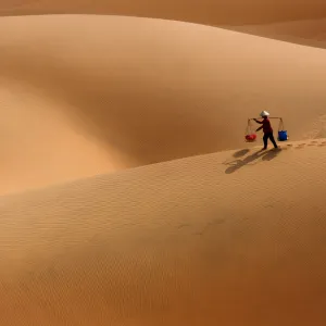 Burden Woman in Sand dune