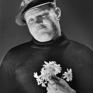 A burly man holding a posy of flowers, circa 1955 A burly man holding a posy of flowers, circa 1955
