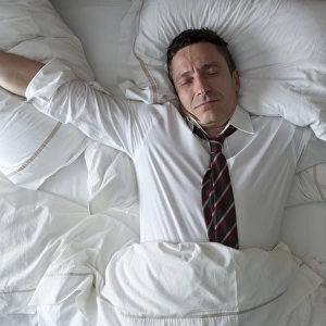Businessman waking up with clothes on