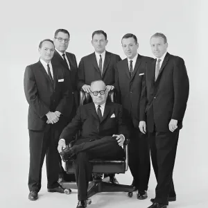 Businessmen against white background, portrait