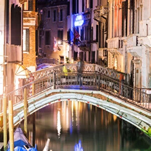 Canal at night with gondola, Venice, Italy