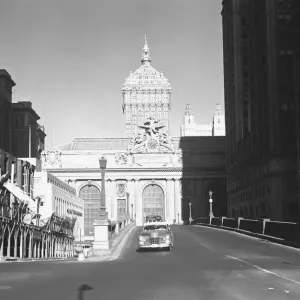 Car riding on street, Grand Central Station in background, New York City, USA, (B&W) Car riding on street, Grand Central Station in background, New York City, USA, (B&W)