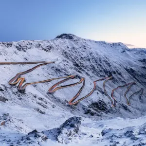 Car trails lights on bends of Stelvio Pass mountain road, South Tyrol, Italy