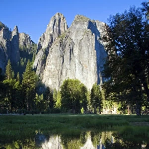 Cathedral Rocks are reflected in a pool of water in Yosemite National Park, CA