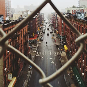 Chinatown seen through fence on a foggy day, NYC