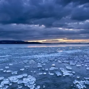 Chunks of ice lying on icy surface on the shore of Reichenau Island, Baden-Wuerttemberg, Germany, Europe Chunks of ice lying on icy surface on the shore of Reichenau Island, Baden-Wuerttemberg, Germany, Europe