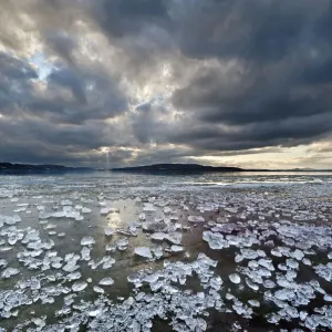 Chunks of ice lying on icy surface on the shore of Reichenau Island, Baden-Wuerttemberg, Germany, Europe Chunks of ice lying on icy surface on the shore of Reichenau Island, Baden-Wuerttemberg, Germany, Europe