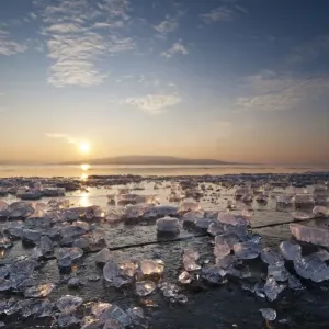 Chunks of ice lying on icy surface on the shore of Reichenau Island at sunset, Baden-Wuerttemberg, Germany, Europe - IMPORTANT Non-exclusive usage, retail calendar, duration Jan. 1, 2016 - Dec. 31, 2016, territory DEU, AUT, CHE - Chunks of ice lying on icy surface on the shore of Reichenau Island at sunset, Baden-Wuerttemberg, Germany, Europe - IMPORTANT Non-exclusive usage, retail calendar, duration Jan. 1, 2016 - Dec. 31, 2016, territory DEU, AUT, CHE -
