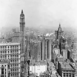 circa 1925: High angle view, looking north, of skyscrapers and traffic on Broadway