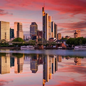 Cityscape of Frankfurt am Main at sunset. Reflection of skyscrapers in the river