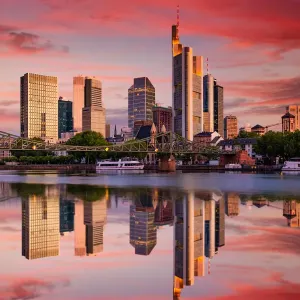 Cityscape of Frankfurt am Main at sunset. Reflection of skyscrapers in the river