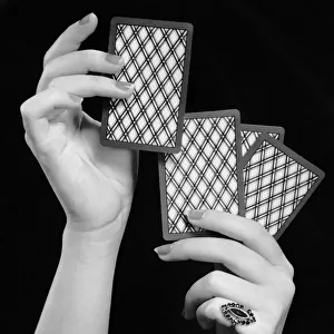 Close-up of womans hands w / playing cards
