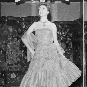 Framed Print of Coco Chanel 1957-58 Apricot Chiffon Evening Dress Print.  Framed Print from Fine Art Storehouse