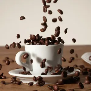 Coffee beans being poured into a cup Coffee beans being poured into a cup