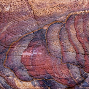 A colourful sandstone wall eroded in a design