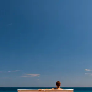 Contemplation on a bench facing the sea Contemplation on a bench facing the sea
