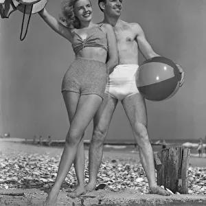 Couple on beach w / beach ball
