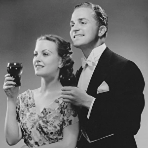 Couple dressed up holding drinks