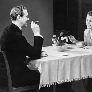 Couple having coffee at table (B&W)